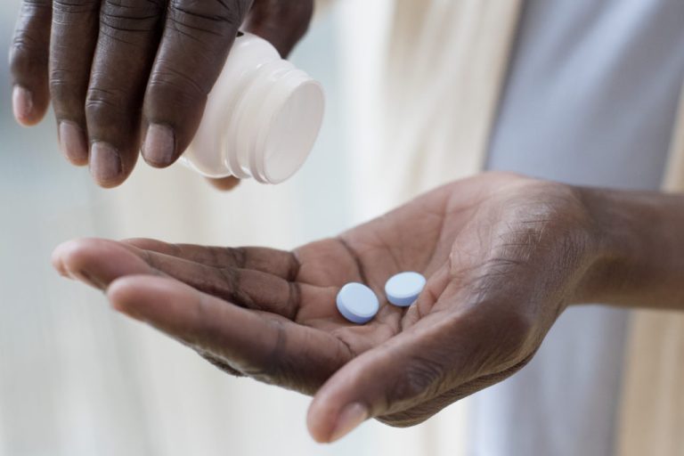 Woman pouring pills